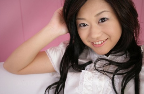 Cute Japanese model Minako Oyama poses non nude in a blouse and skirt