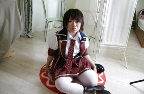 Asian schoolgirl Mayu Nakane revealing her nice ass and inviting gash