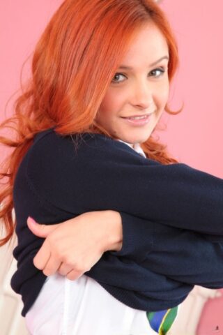 Stunning British redhead Elle Richie teases and reveals her natural tits