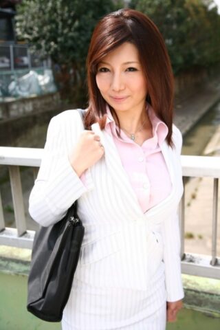 Fully clothed Japanese model Sayuri Mikami walks the street in a business suit