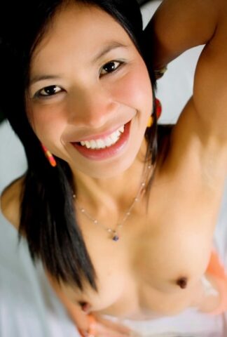 Skinny babe Dang unveils her trimmed pussy in a sexy striptease on her bed