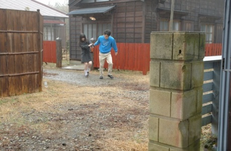 Asian honey Mai Shimizu kneels in front of a guy and gives head outdoors
