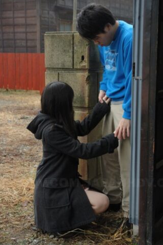 Asian honey Mai Shimizu kneels in front of a guy and gives head outdoors