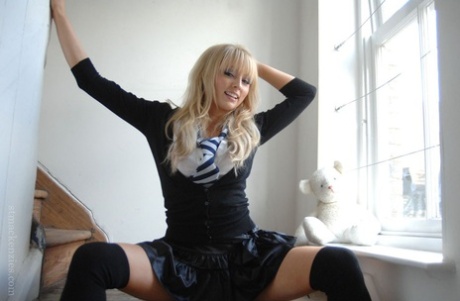 Adorable babe in black socks Elle Parker taking off her school uniform