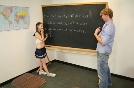 Little teen giving her tall blonde teacher a great handjob in the classroom