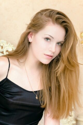 Beautiful teen Mendes A exposes her tiny boobs and poses naked on a bed