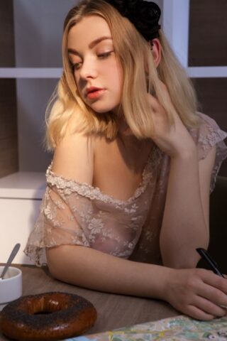 Blonde beauty Daniel Sea shows her splendid tits and poses nude on a chair