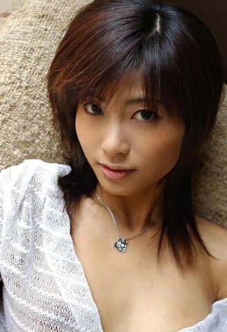 Beautiful Japanese girl Rin Suzuka lets a firm breast loose during solo action