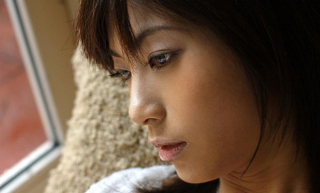 Beautiful Japanese girl Rin Suzuka lets a firm breast loose during solo action