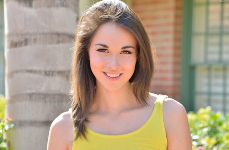 Gorgeous brunette teen strips out of her yellow dress in public