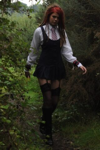 Tall schoolgirl shows off her hot legs in stockings and boots outdoors