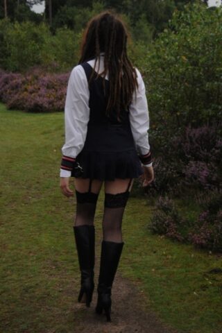 Tall schoolgirl shows off her hot legs in stockings and boots outdoors