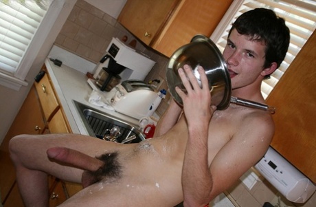 Naughty gay Devin Moss strips naked & jerks his big dick while baking