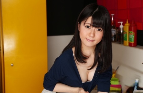 Japanese chick Mai Araki shows her ass and snatch while in the kitchen