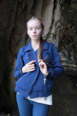 Sweet teen with pigtails Milena D reveals her bushy twat and poses on a couch