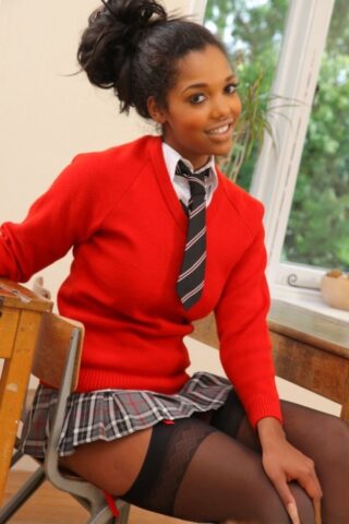 Ebony Rehea flashes her breasts and poses in black stockings in the classroom