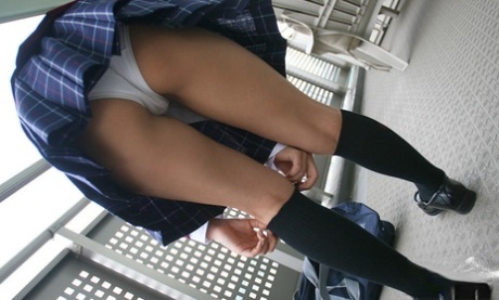 Lusty asian coed in uniform flashing her panties and tiny tits