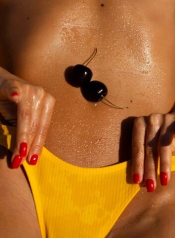 Italian babe Natalia Andreeva flaunts her tanned body & big tits on the beach