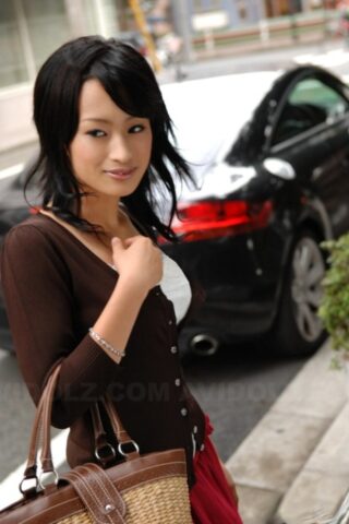 Japanese beauty Mio Kanna strolls downtown in a knee-length skirt