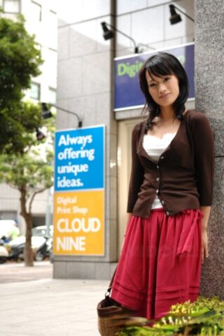 Japanese beauty Mio Kanna strolls downtown in a knee-length skirt