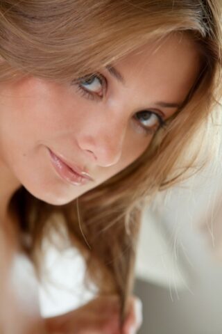 Absolutely gorgeous teen Edwige A shows her trimmed cunt on a bed up close